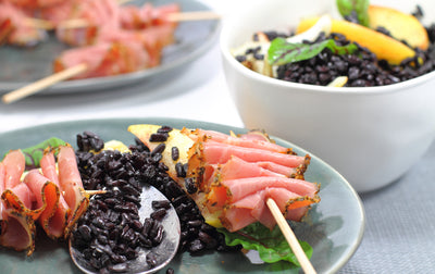 Black fennel and apple rice with pastrami skewers